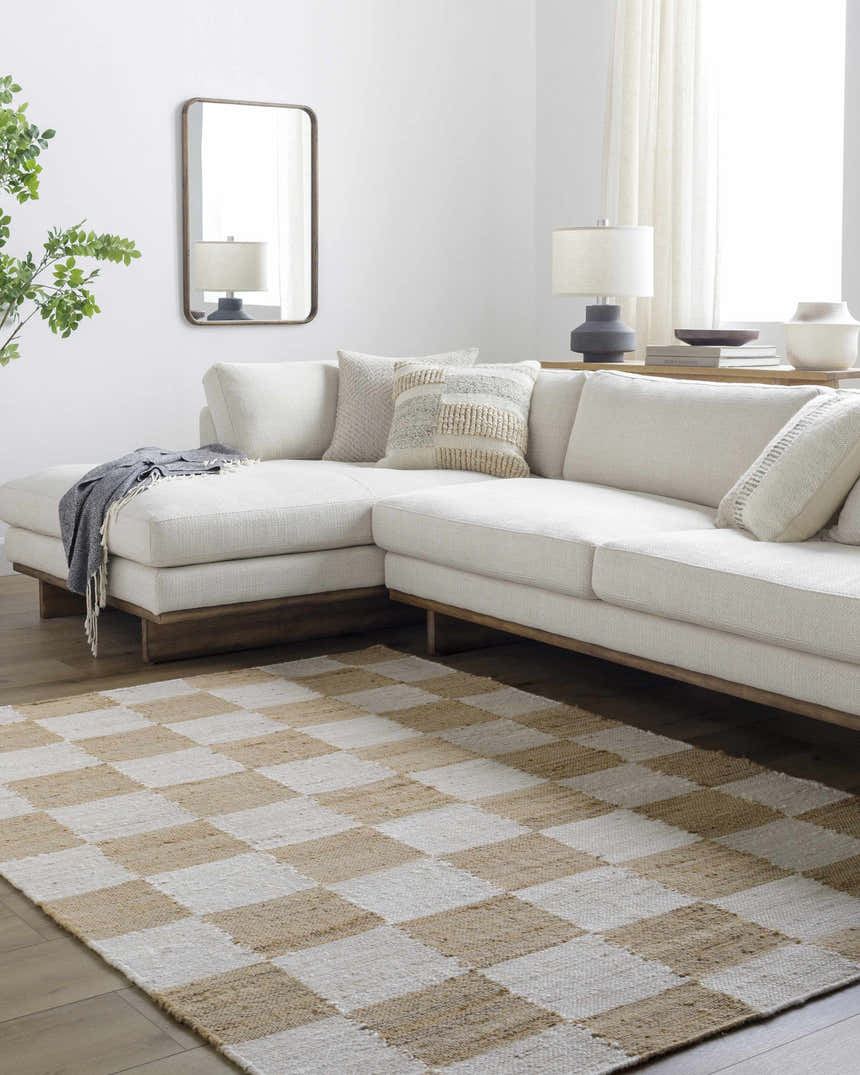 Living room with a Becki Owens x LIVABLISS BOKY-2302 area rug in a light brown and white checkerboard pattern under a cream sectional. Roomscene-Rectangle