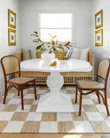 Dining room with Becki Owens x LIVABLISS BOKY-2302 rug, white table, wicker bench, and wood chairs. Farmhouse style. Roomscene-Rectangle