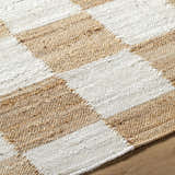 Close up of Kamey Handmade Becki Owens x LIVABLISS rug showing a light brown and white woven checkerboard pattern. Texture