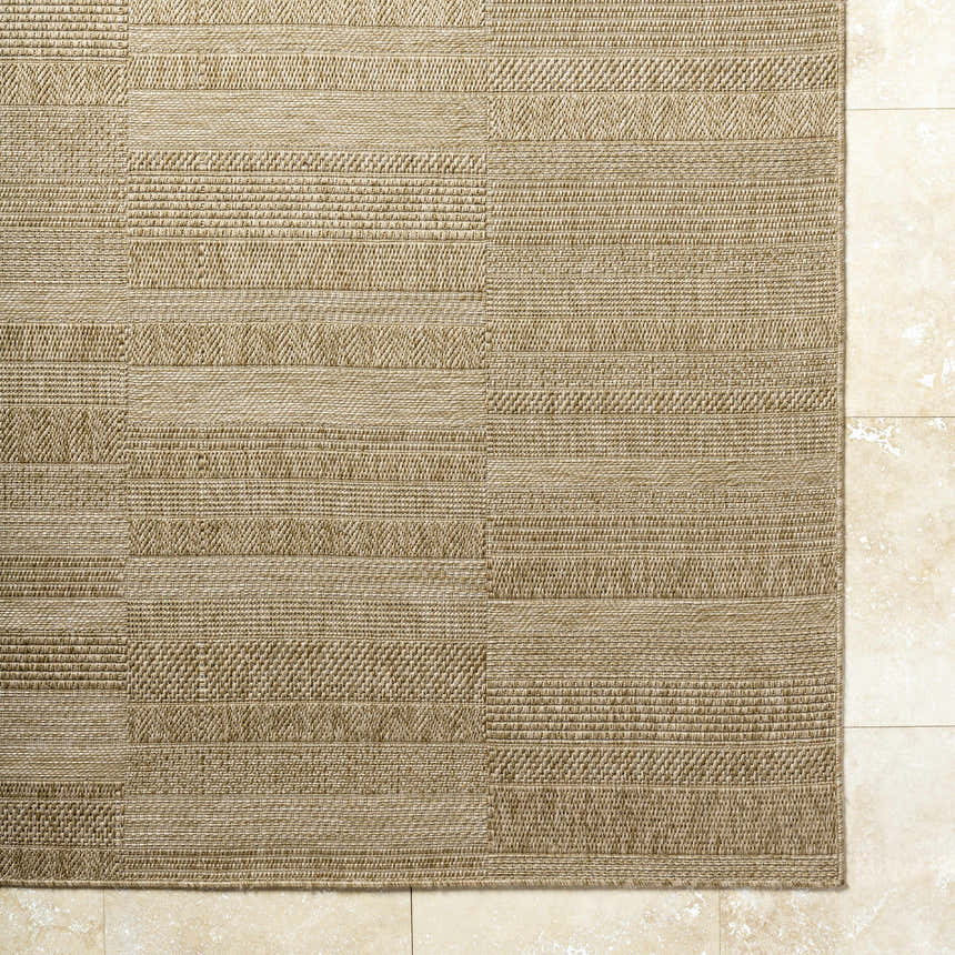 Close-up of the Thana Brown Area Rug showing its woven texture and geometric pattern in camel, tan, and prairie dust. Corner