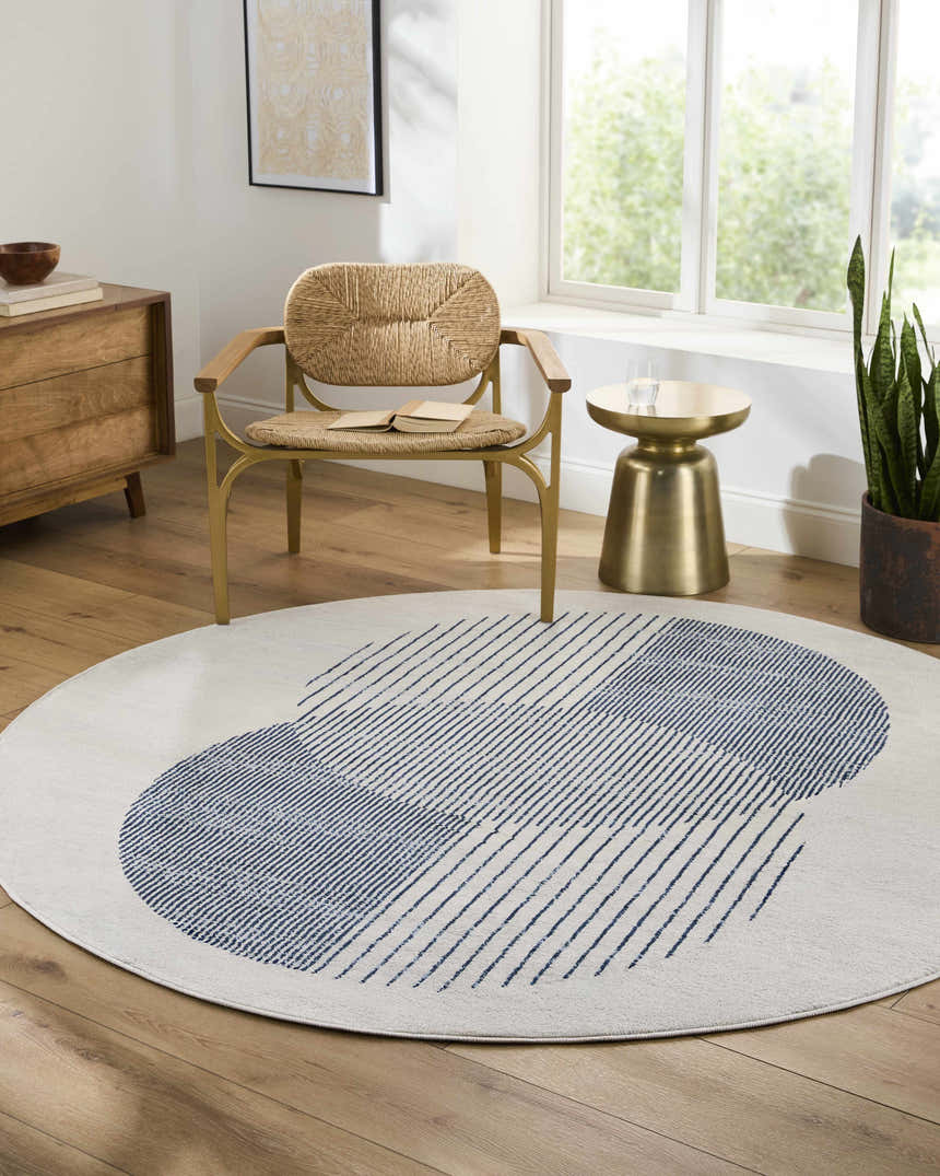 Living room scene with a round Usra Area Rug in white and blue geometric pattern. Roomscene-Round