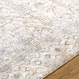 Close-up of the Avalyn Area Rug, a machine-woven rug in cream, light sage, light slate, sage and tan colors. Texture