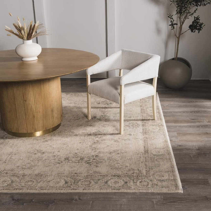 Dining room scene with a beige Fetscher II Vintage Medallion Area Rug, round table, and upholstered chair. Roomscene-Rectangle