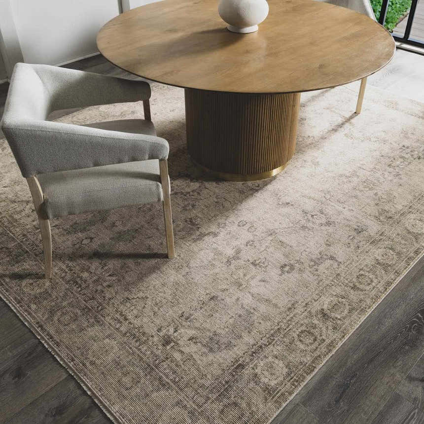 Dining room scene with a round wood table, gray chair, and beige Fetscher II Vintage Medallion Area Rug. Roomscene-Rectangle