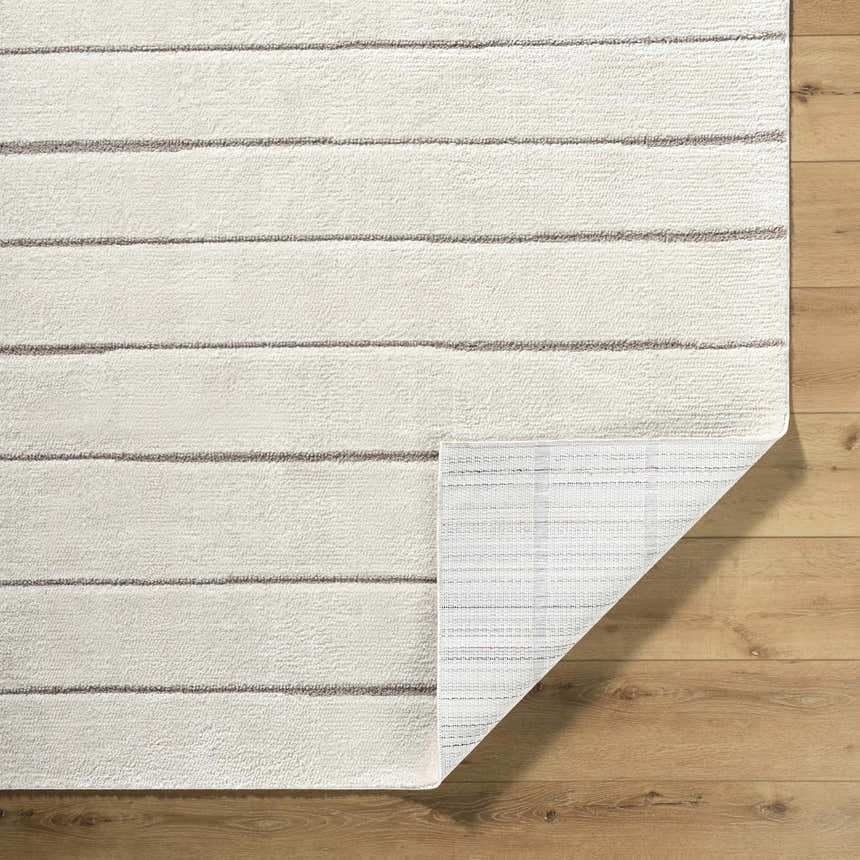 Close-up of the Cascade Machine Woven PNW Home x LIVABLISS PNWCS-2303 Area Rug, ivory and taupe stripes, showing backing. Fold