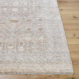 Close-up of Vince Area Rug showing cream, gray, and tan farmhouse design on wood floor. Machine woven polyester rug. Front