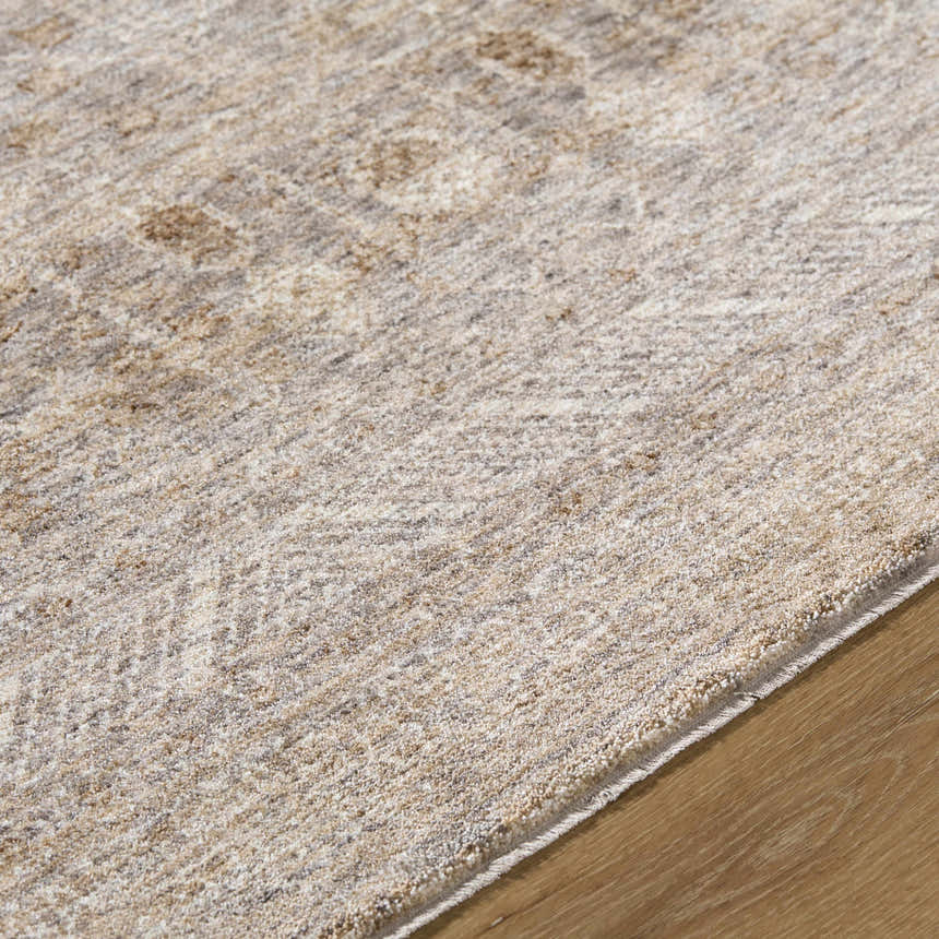 Close-up of the Vince Area Rug showing cream, tan, and gray tones with a subtle traditional pattern. Texture