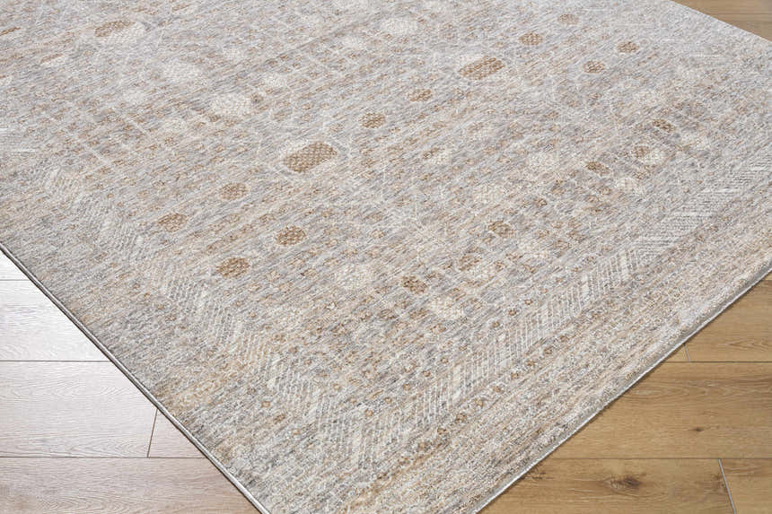 Close-up of the Vince Area Rug. Cream, dark red, gray, and tan farmhouse style rug with a traditional pattern. Corner
