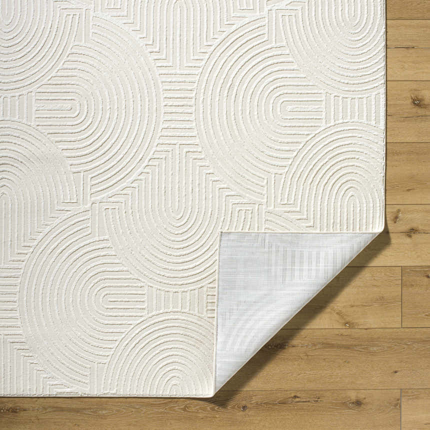 Close-up of the Aucoin Cream 3D Rainbow Washable Area Rug, showing its geometric pattern and textured design. Fold