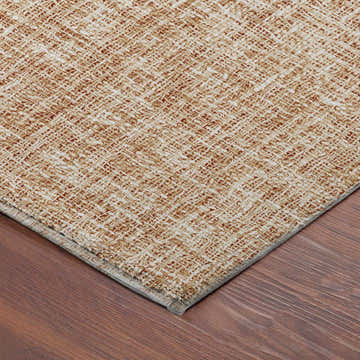 Close-up of the caramel-colored Dalyn Luxury Voyage VY1 Copper Washable Area Rug showing its woven texture.