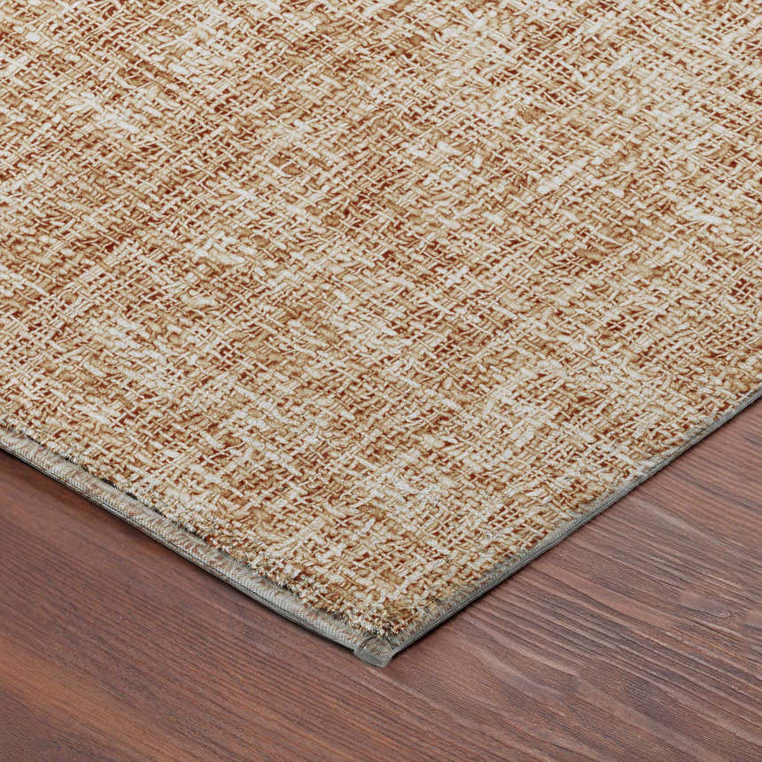 Close-up of the caramel-colored Dalyn Luxury Voyage VY1 Copper Washable Area Rug showing its woven texture.