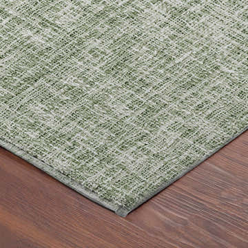 Close-up of the green Dalyn Luxury Voyage VY1 Fern Washable Area Rug showing woven texture and color variation.