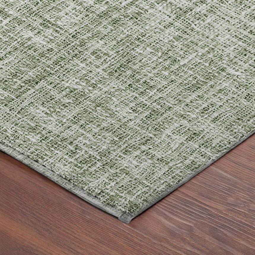 Close-up of the green Dalyn Luxury Voyage VY1 Fern Washable Area Rug showing woven texture and color variation.
