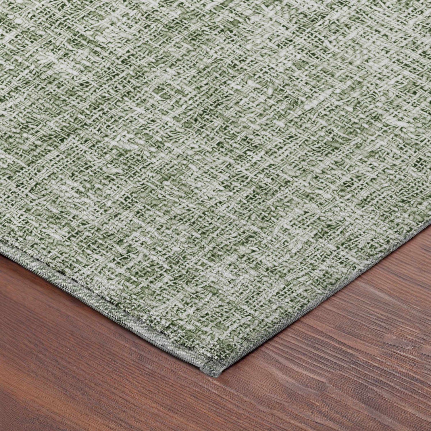 Close-up of the green Dalyn Luxury Voyage VY1 Fern Washable Area Rug showing woven texture and color variation.