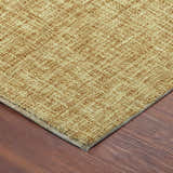 Close-up of the gold Dalyn Luxury Voyage VY1 rug showing its woven texture and neutral border on wood floor.