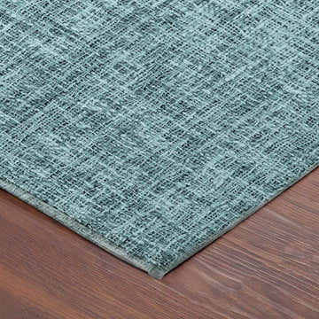 Close-up of the teal Dalyn Luxury Voyage washable area rug showing its woven texture and neutral border.