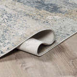 Close-up of the Whyalla Misty Thick Luxe Rug showing its dusty sage, light gray, and navy abstract design and thick pile. Fold