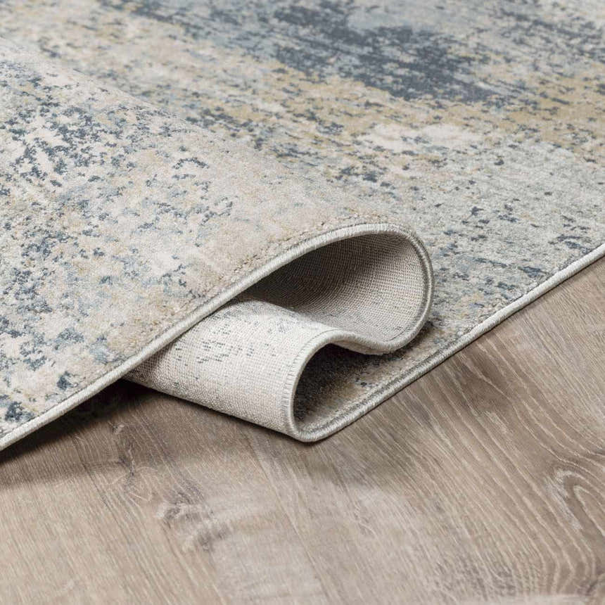Close-up of the Whyalla Misty Thick Luxe Rug showing its dusty sage, light gray, and navy abstract design and thick pile. Fold