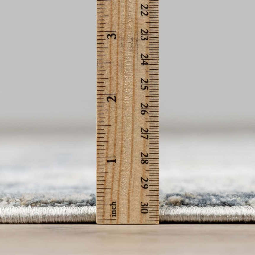 Close-up of Whyalla Misty Thick Luxe Rug pile height, showing its plush, dense texture with a ruler. Pile