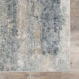 Close-up of the Whyalla Misty Thick Luxe Rug. Features dusty sage, light gray, navy, and taupe colors. Abstract design. Swatch