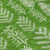 Close-up of Dalyn Wonderland WN21 Green Washable Area Rug. Features a bright green background and white pine tree branch pattern.