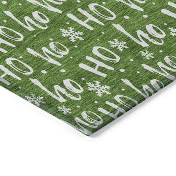 Close up of Dalyn Wonderland Green Washable Area Rug with a festive Ho Ho Ho and snowflake pattern.