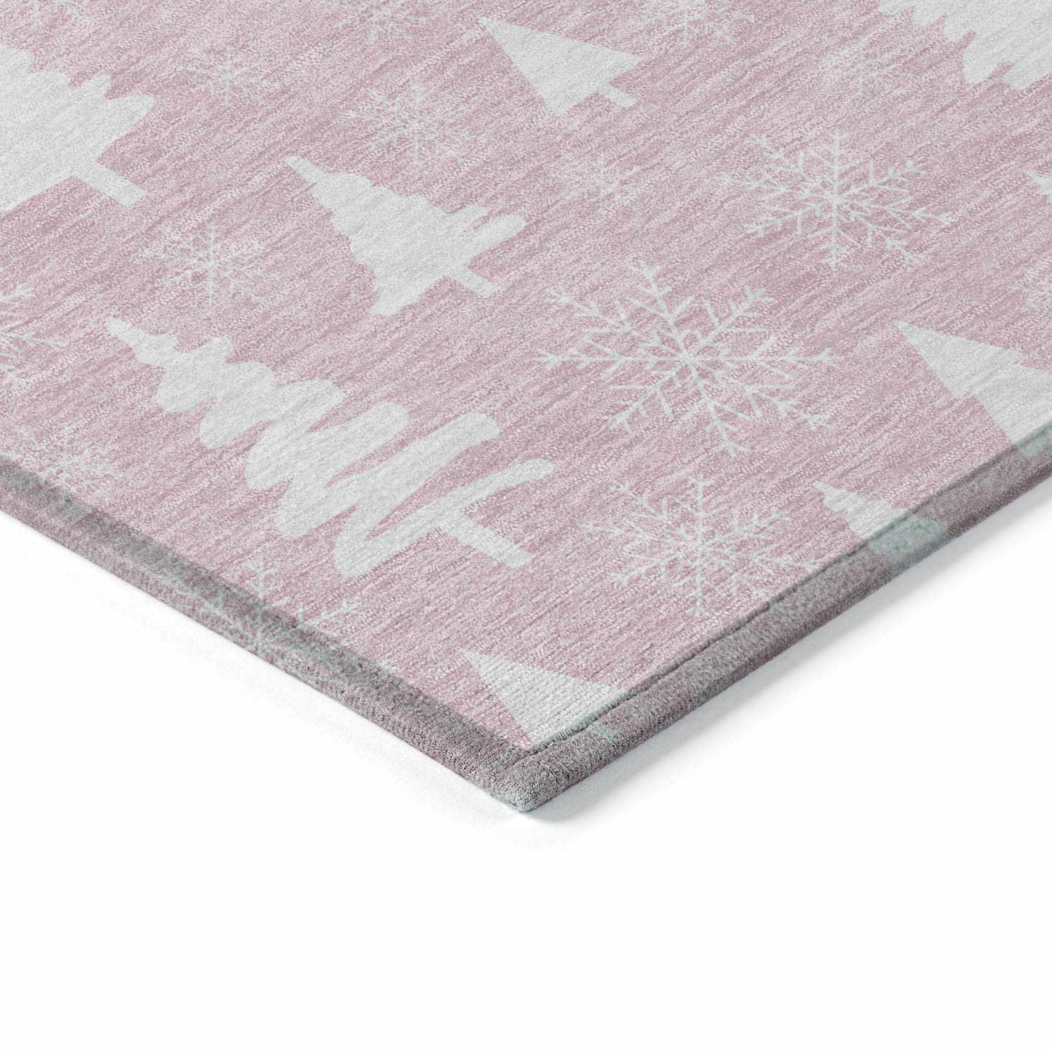 Close-up of Dalyn Wonderland WN23 Pink Washable Area Rug with white Christmas trees and snowflake pattern.