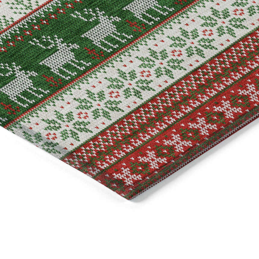 Close up of the Dalyn Wonderland WN26 Red Washable Area Rug. Holiday style with red, green, and white reindeer and snowflake pattern.