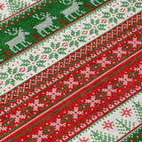 Close-up of Dalyn Wonderland WN26 Red Washable Area Rug. Features a festive red, green, and white holiday pattern.