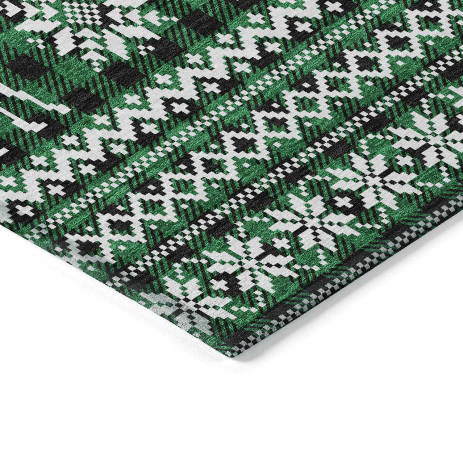 Close-up of the Dalyn Wonderland WN28 Green Washable Area Rug featuring a black, green, and white holiday pattern.