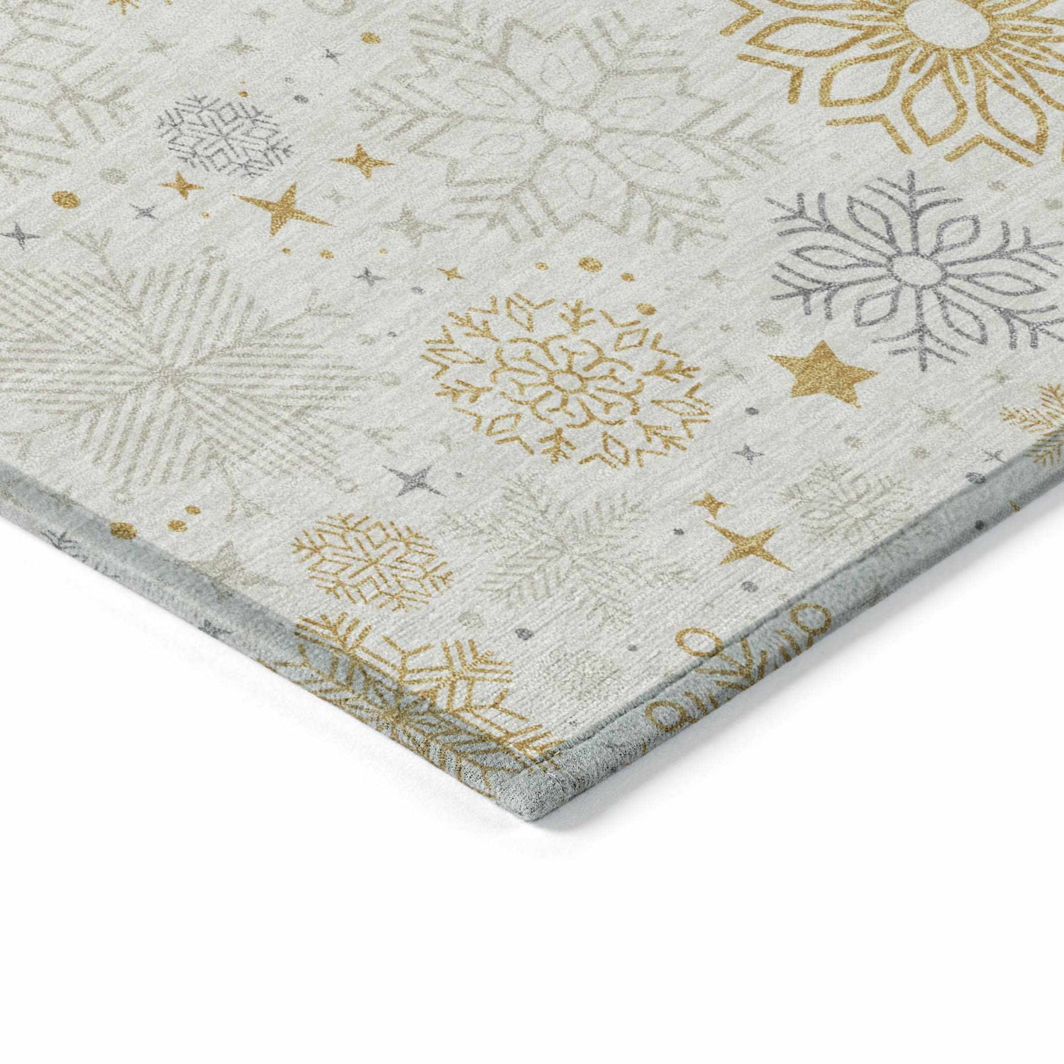 Close-up of Dalyn Wonderland WN31 ivory washable rug. Features gold, taupe, and chestnut snowflake and star pattern.