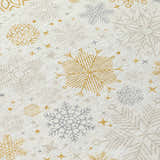 Close-up of Dalyn Wonderland WN31 Ivory Washable Area Rug with gold, taupe, and chestnut snowflake pattern.