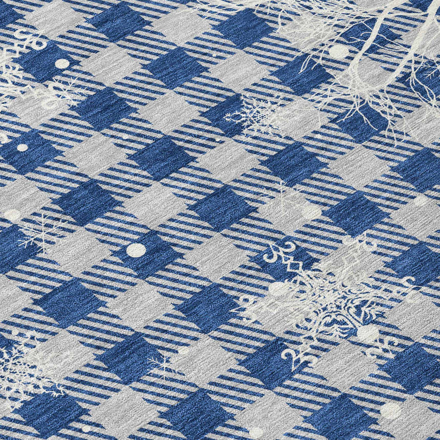 Close-up of Dalyn Wonderland WN32 Blue Washable Area Rug. Features a blue and taupe plaid pattern with snowflakes.