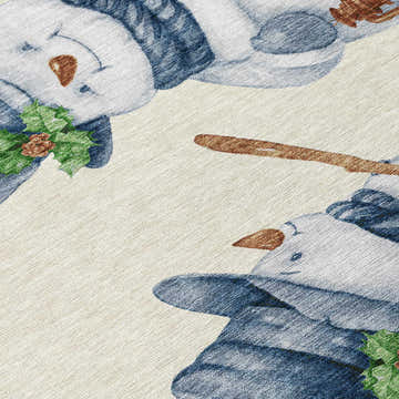 Close-up of the Dalyn Wonderland WN34 Ivory Washable Area Rug featuring a snowman and holly design. Holiday style.