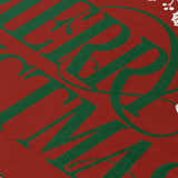 Close-up of the Dalyn Wonderland WN6 Red Washable Area Rug. Red background with green holiday text.
