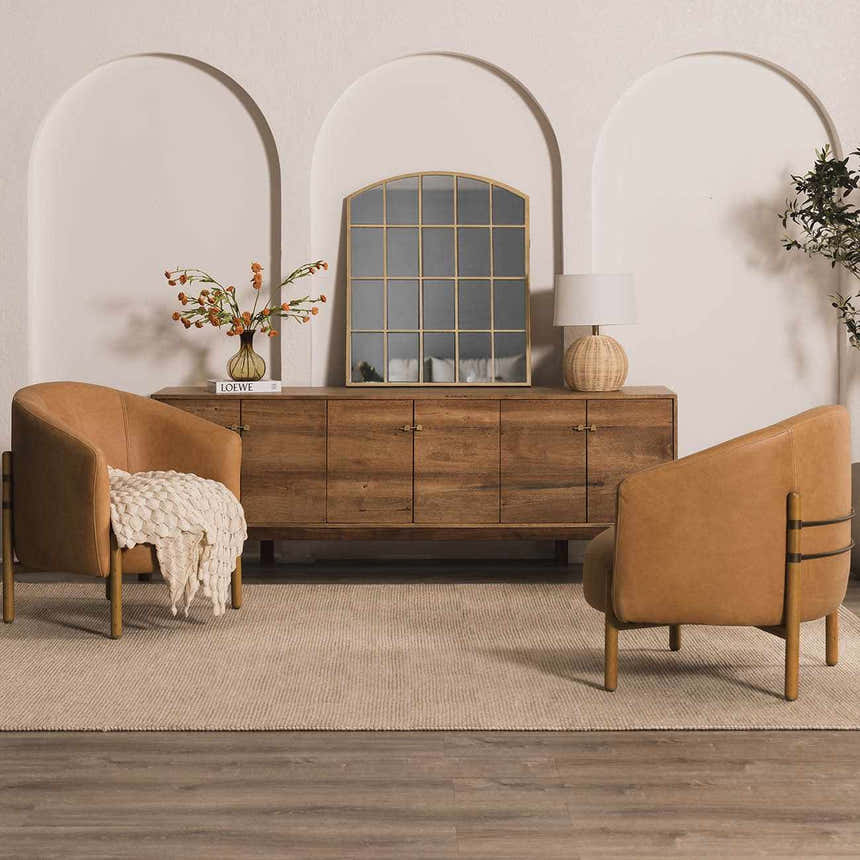 Living room scene with tan leather chairs on a Wolseth Area Rug. Rustic wood cabinet and arched doorways create a cozy mood. Roomscene-Rectangle