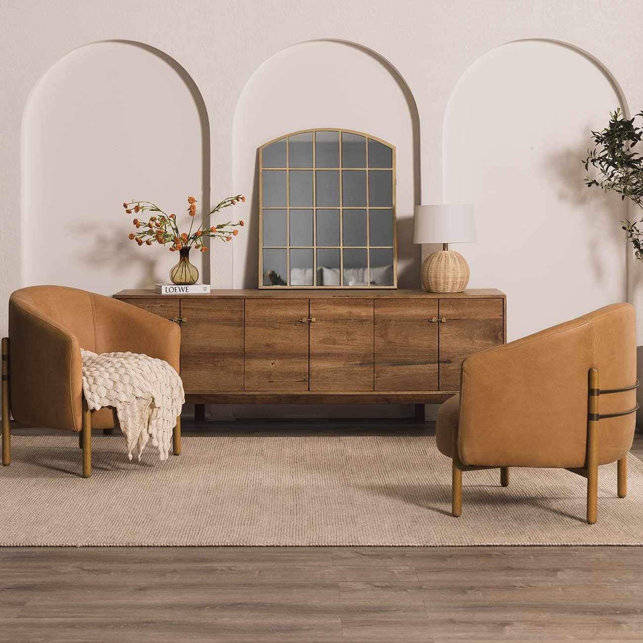 Living room scene with tan leather chairs on a Wolseth Area Rug. Rustic wood cabinet and arched doorways create a cozy mood. Roomscene-Rectangle