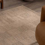 Close-up of the ivory Wolseth Area Rug showing its hand woven texture and subtle geometric pattern. Styleshot