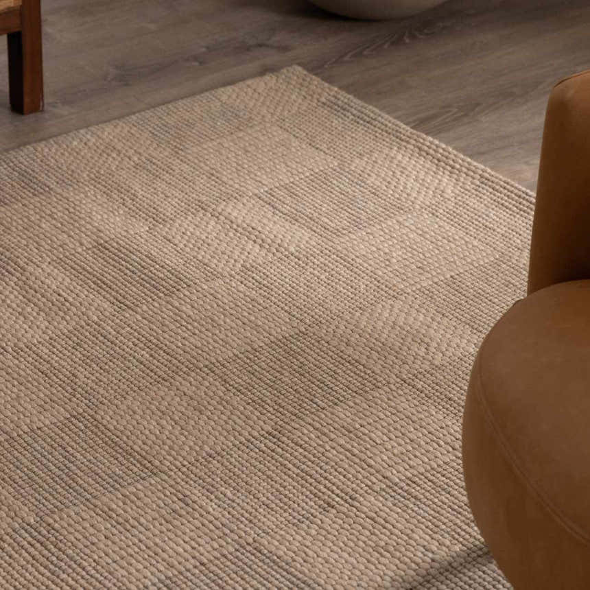 Close-up of the ivory Wolseth Area Rug showing its hand woven texture and subtle geometric pattern. Styleshot