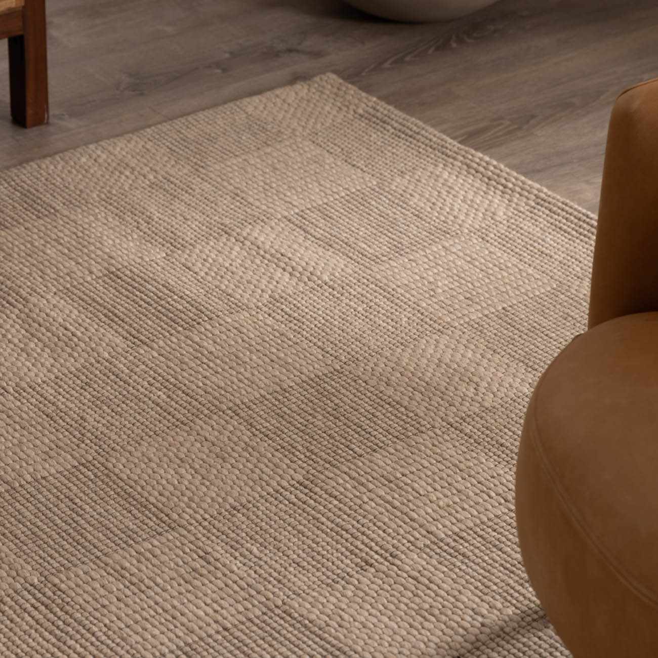 Close-up of the ivory Wolseth Area Rug showing its hand woven texture and subtle geometric pattern. Styleshot