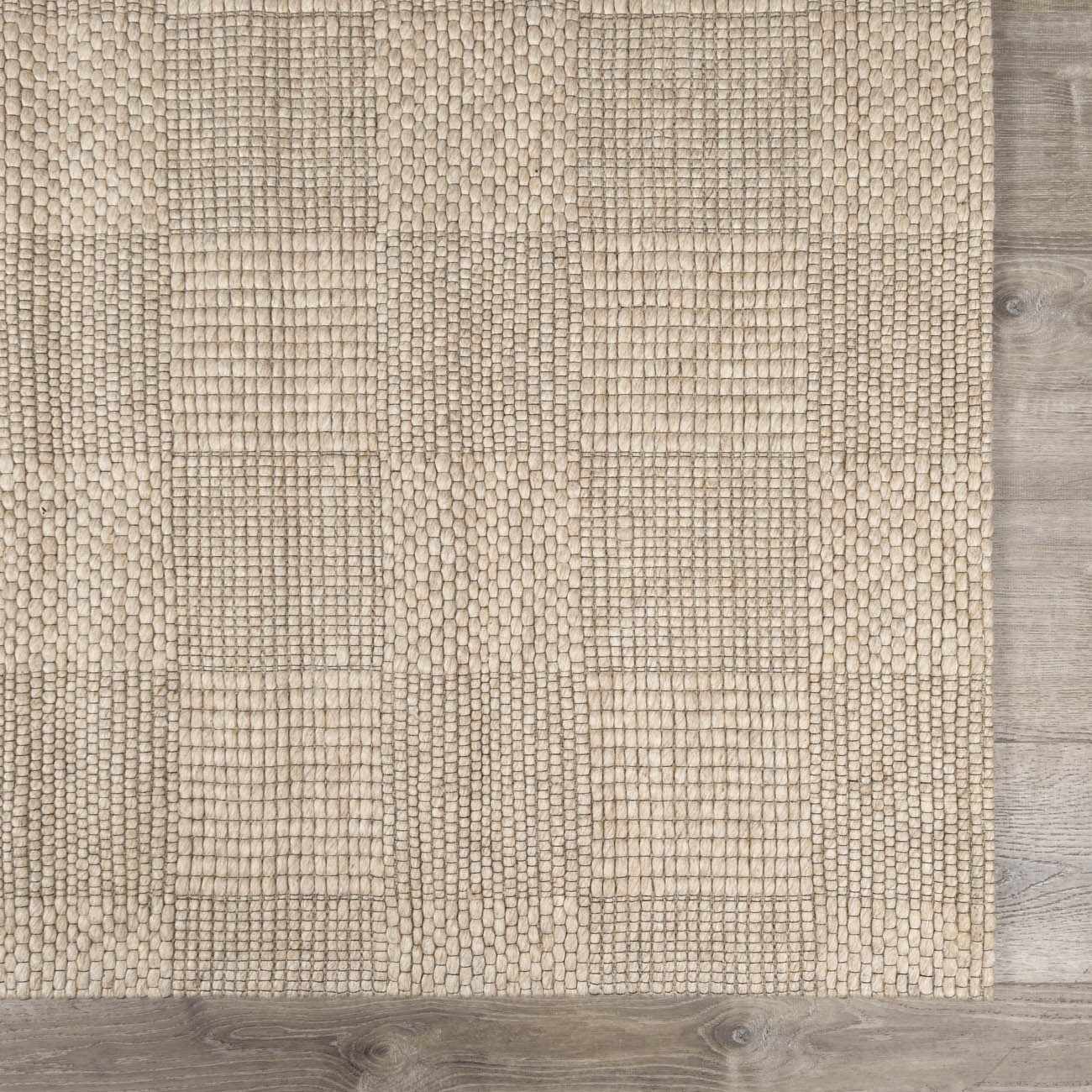 Close-up of the hand-woven Wolseth Area Rug, off-white color, with a subtle geometric pattern and textured wool and polyester blend. Swatch