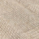 Close-up of the hand-woven Wolseth Area Rug, showing its textured ivory wool and polyester blend. Texture
