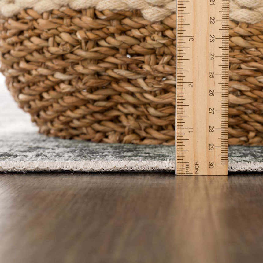 Close-up of the Gray Holi-4607 Washable Area Rug showing its texture, edge, and thickness with a ruler for scale. Pile