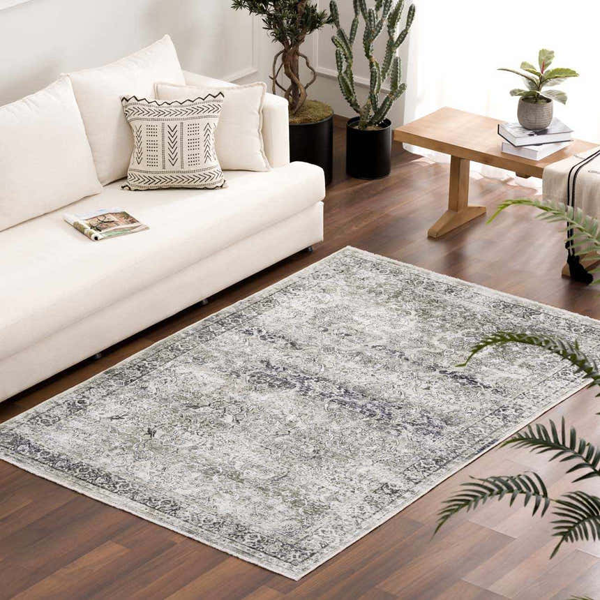 Living room scene with a white sofa and the Gray Holi-4607 Washable Area Rug. The rug has a vintage, traditional pattern in gray and white. Roomscene-Rectangle