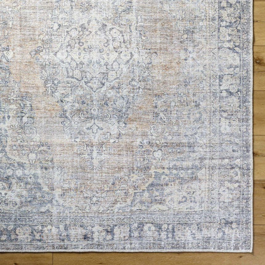 Close-up of the gray, light silver, and prairie dust Yachi Washable Area Rug showing its farmhouse traditional pattern. Swatch