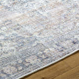 Close-up of the Yachi Washable Area Rug showing its traditional gray, silver, and prairie dust pattern and woven texture. Texture