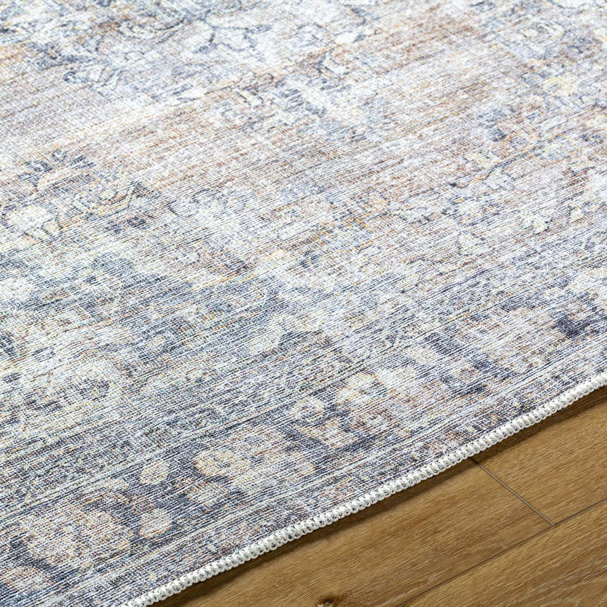 Close-up of the Yachi Washable Area Rug showing its traditional gray, silver, and prairie dust pattern and woven texture. Texture