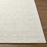 Close-up of the hand-tufted Yadid Cream Wool Area Rug showing its ash and pearl farmhouse pattern and texture. Front