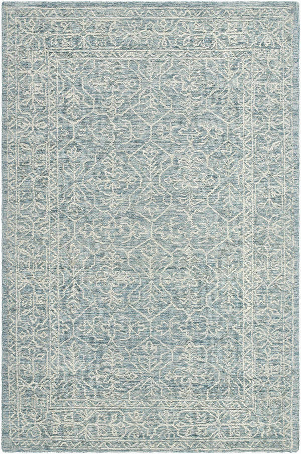 Close-up of the Yadid Area Rug. Hand-tufted wool rug in light blue with a traditional white floral pattern and border. Design-Rectangle-576