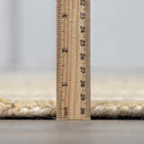 Close-up of the Yoyko Area Rug pile height, showing its thick, hand-tufted wool construction. Pile